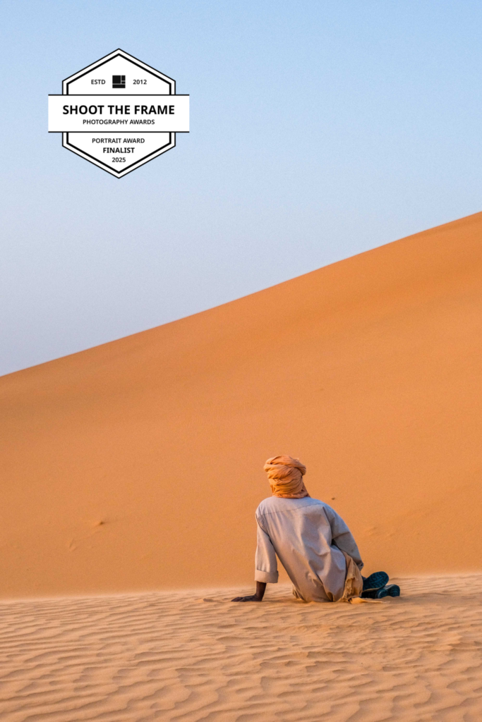 a portrait of a nomad on the dunes in Djanet Algeria by Maxine Noel